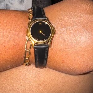 Movado ladies watch with gold tone, black face leather band